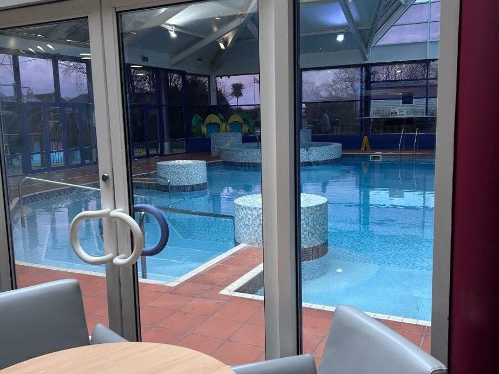 an indoor swimming pool area with seating at Cala Gran Holiday Park - Holiday Accommodation 21106 in Fleetwood