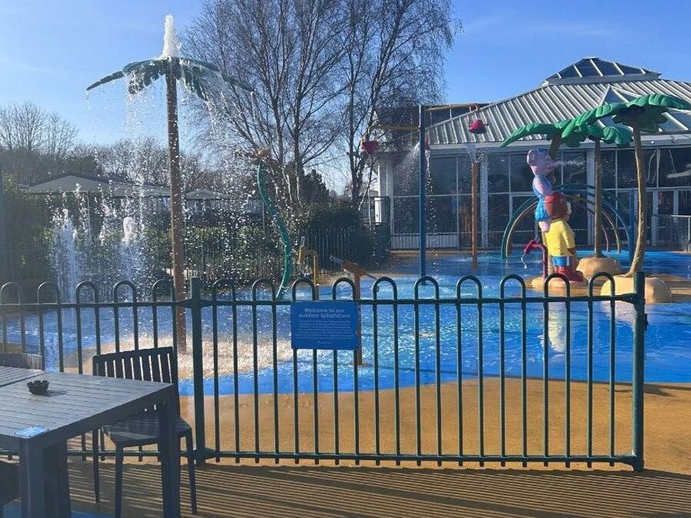 a water play area with palm trees and a colorful play structure at Cala Gran Holiday Park - Holiday Accommodation 21106 in Fleetwood