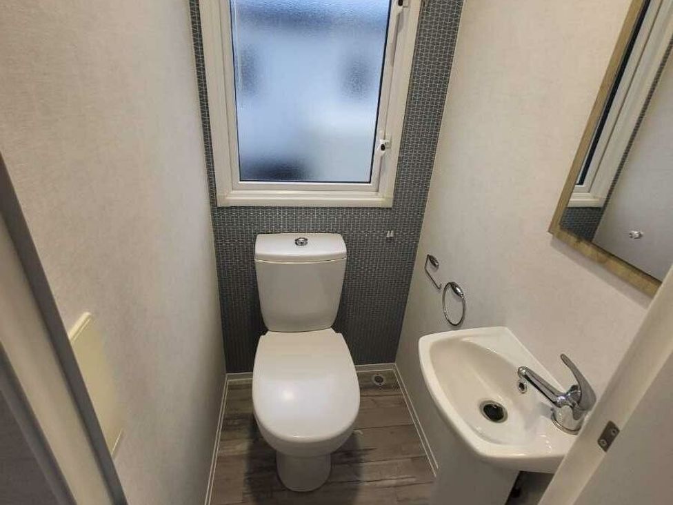 a small bathroom with a toilet and sink at Ty Mawr Holiday Park - Holiday Accommodation 21121, Ty Mawr