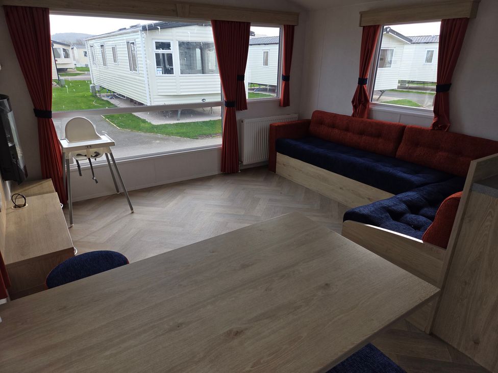 A living room with a couch and table at Ty Mawr Holiday Park - Holiday Accommodation 21121 Ty Mawr