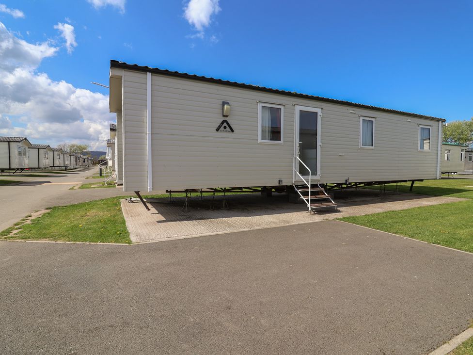 A static caravan with steps and windows at Ty Mawr Holiday Park - Holiday Accommodation 21121 Ty Mawr
