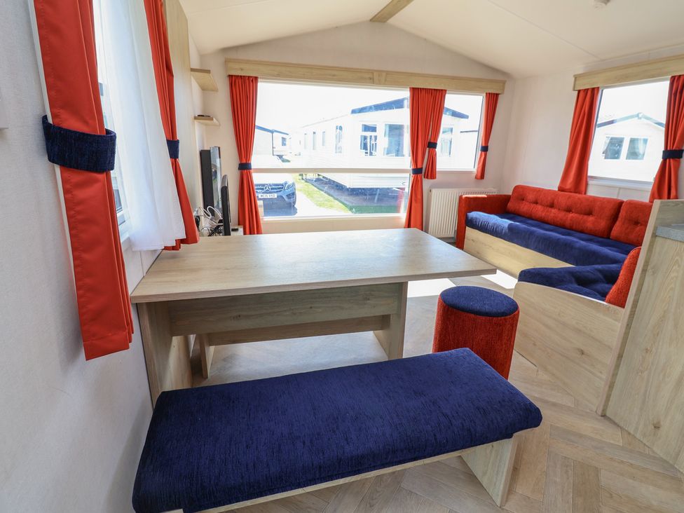 A living room with a table and sofa at Ty Mawr Holiday Park - Holiday Accommodation 21121, Ty Mawr