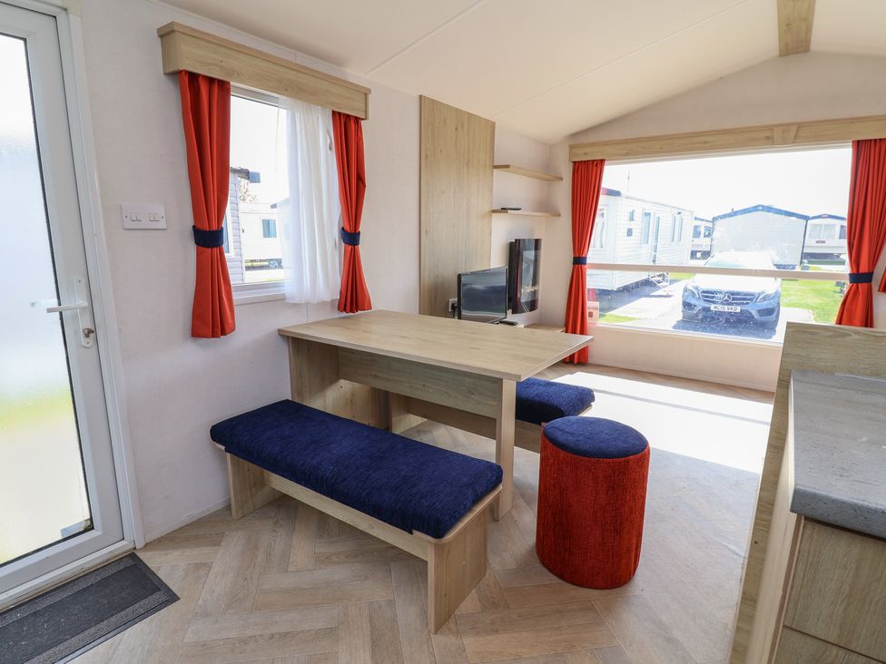 A dining area with a table and chairs at Ty Mawr Holiday Park - Holiday Accommodation 21121 Ty Mawr