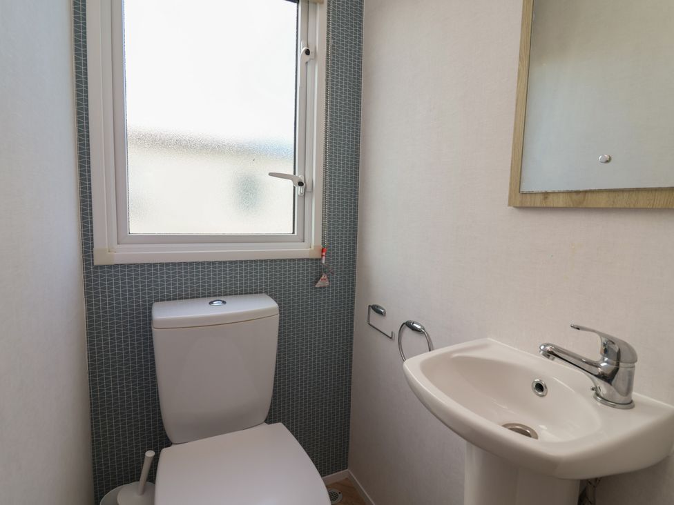 A bathroom with a toilet and sink at Ty Mawr Holiday Park - Holiday Accommodation 21121, Ty Mawr