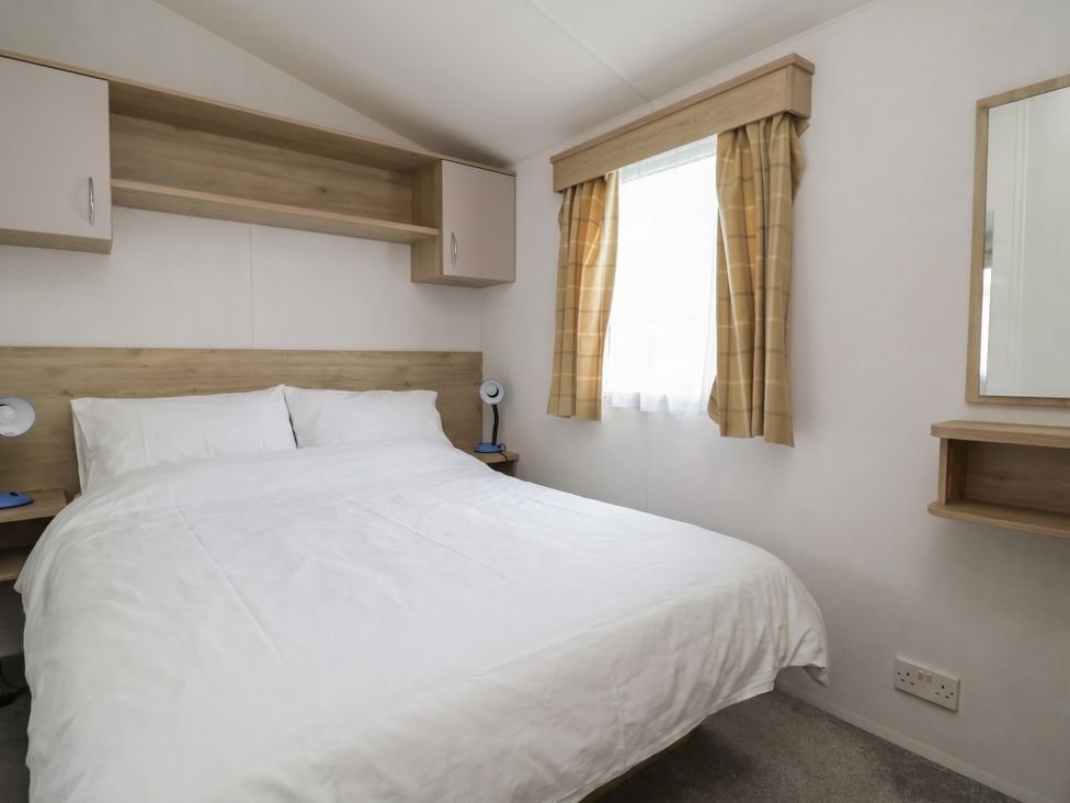 A bedroom with a double bed and a shelf at Ty Mawr Holiday Park - Holiday Accommodation 21121 Ty Mawr