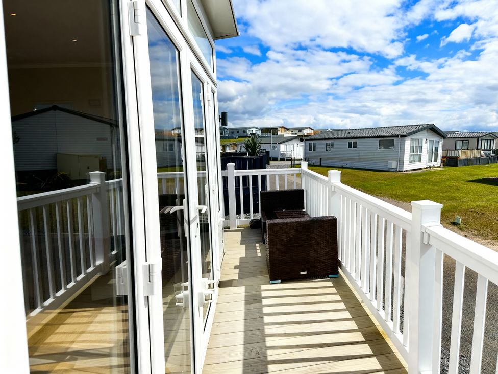 A deck area with chairs at Ocean Edge Leisure Park - Holiday Accommodation 21286 Morecambe