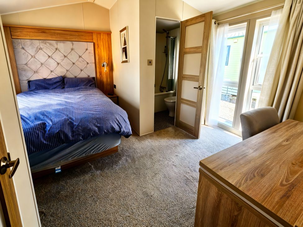 A bedroom with a bed and desk at Ocean Edge Leisure Park - Holiday Accommodation 21286 Morecambe