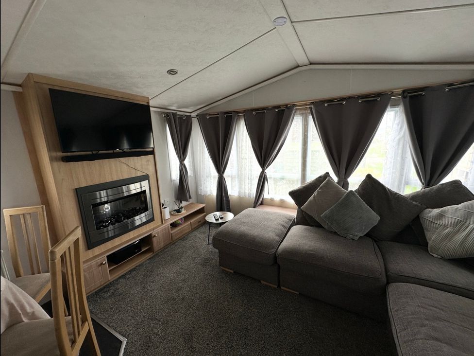 A living room with a sofa and television at Whitehouse Leisure Park - Holiday Accommodation 21355, Towyn