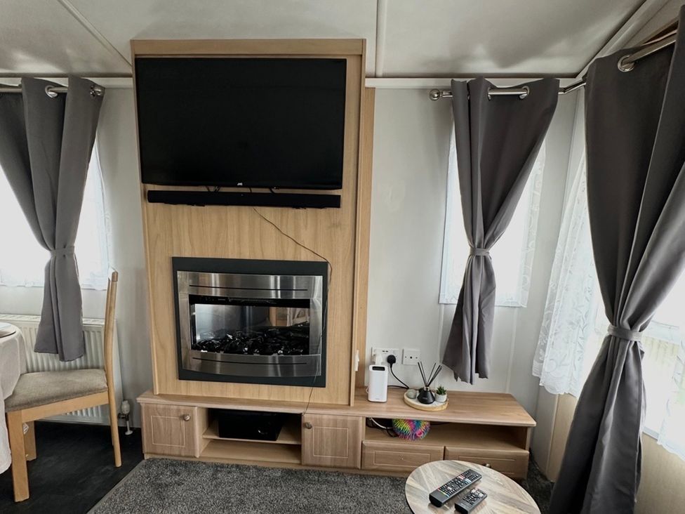 A living room with television and fireplace at Whitehouse Leisure Park - Holiday Accommodation 21355 Towyn