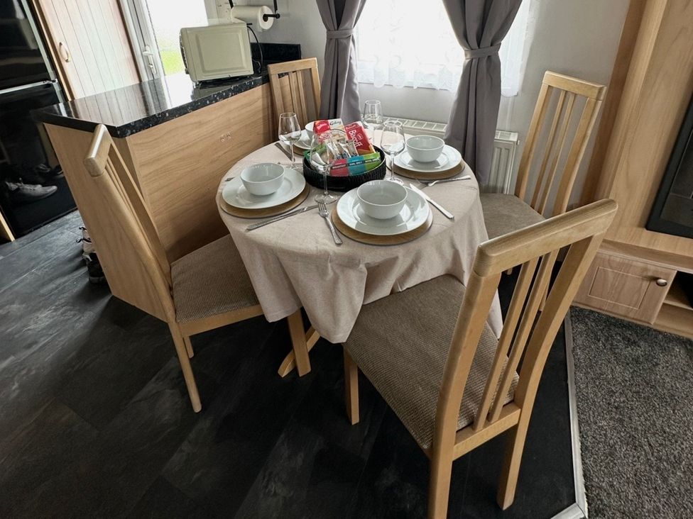 A dining room with a table set for dinner at Whitehouse Leisure Park - Holiday Accommodation 21355 Towyn