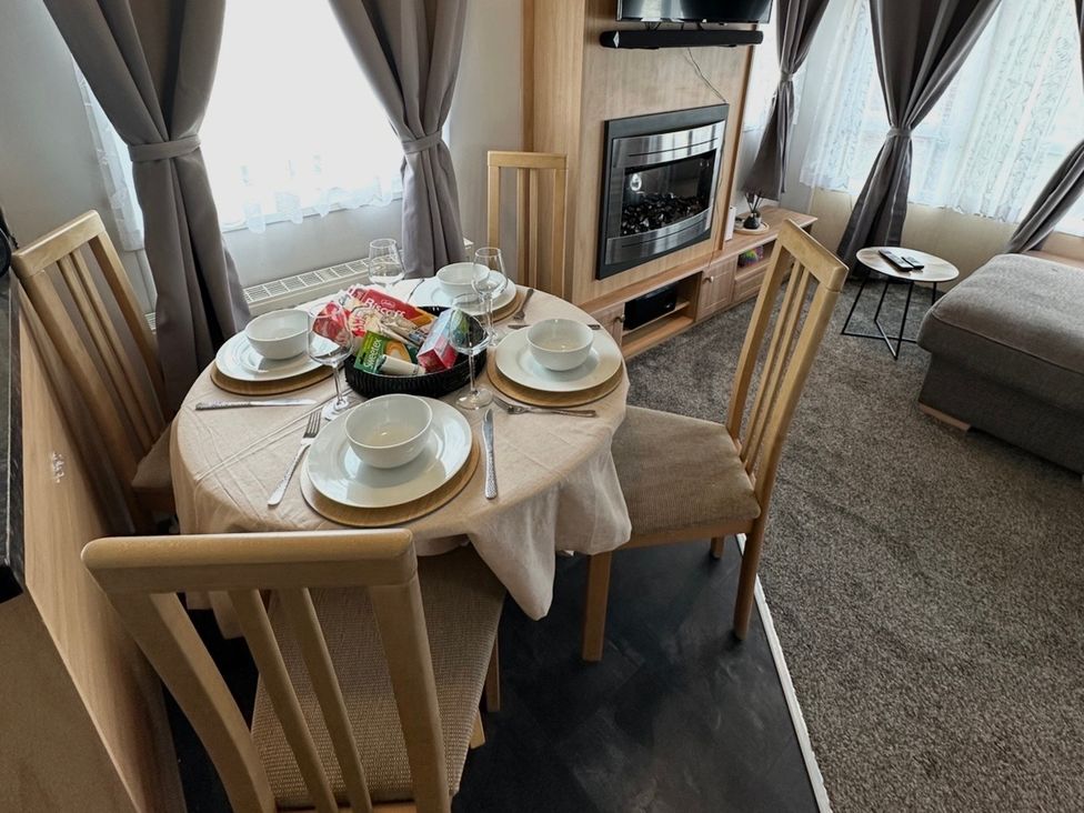 A dining table set with bowls and glasses at Whitehouse Leisure Park - Holiday Accommodation 21355 in Towyn