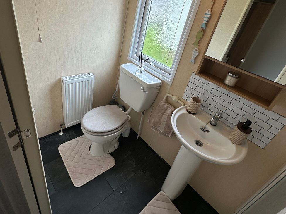 A bathroom with a sink and toilet at Whitehouse Leisure Park - Holiday Accommodation 21355 Towyn
