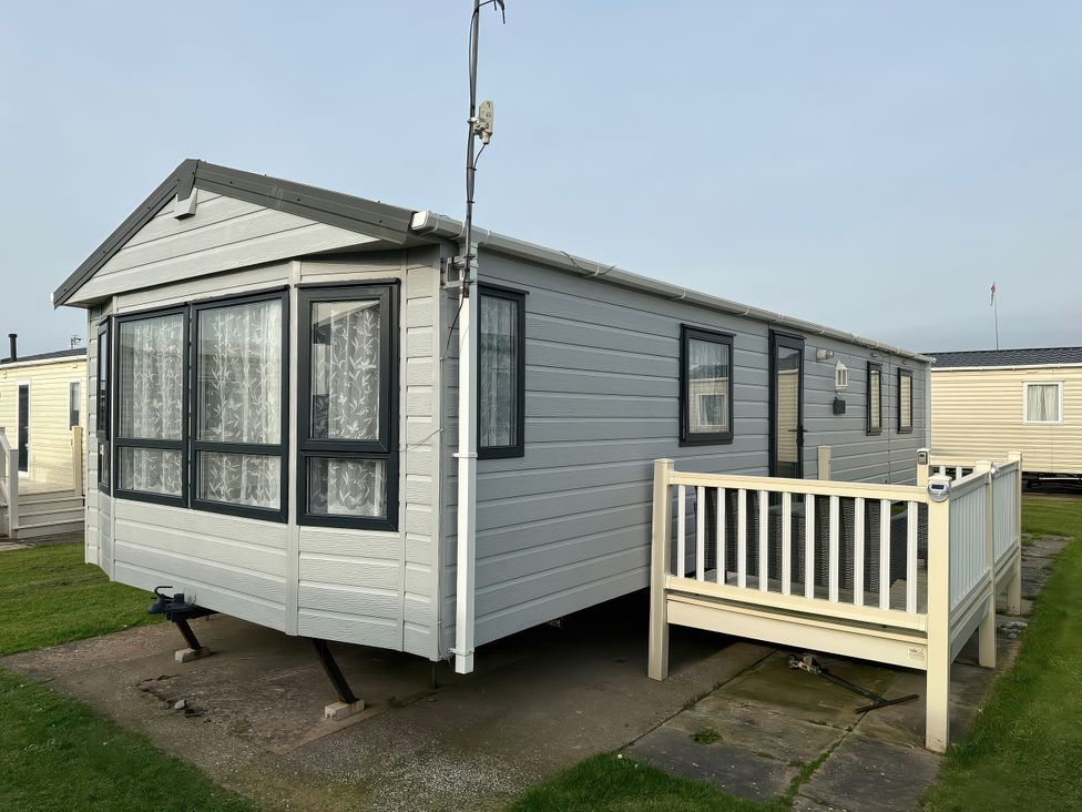 A caravan with a balcony and windows at Whitehouse Leisure Park - Holiday Accommodation 21355 Towyn