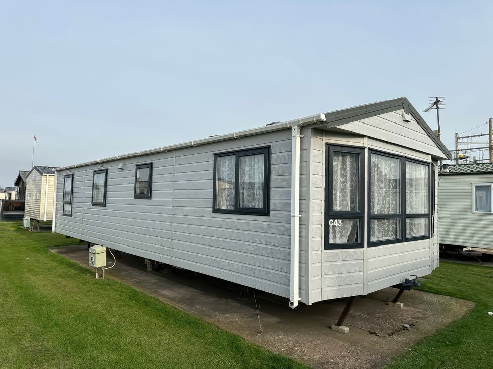 A static caravan with a number C43 outdoors at Whitehouse Leisure Park - Holiday Accommodation 21355 Towyn