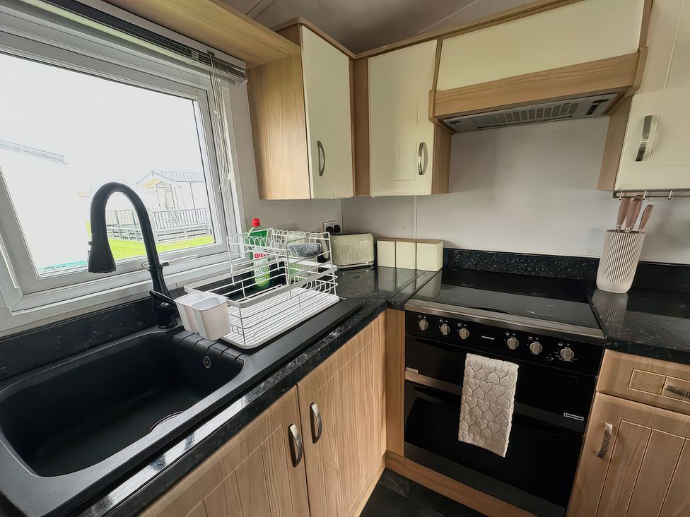 A kitchen with a sink and stove at Whitehouse Leisure Park - Holiday Accommodation 21355 Towyn