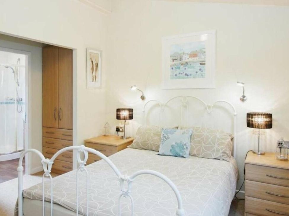 a bedroom with a bed and nightstands at St Minver Holiday Park - Holiday Accommodation 21443 in Wadebridge