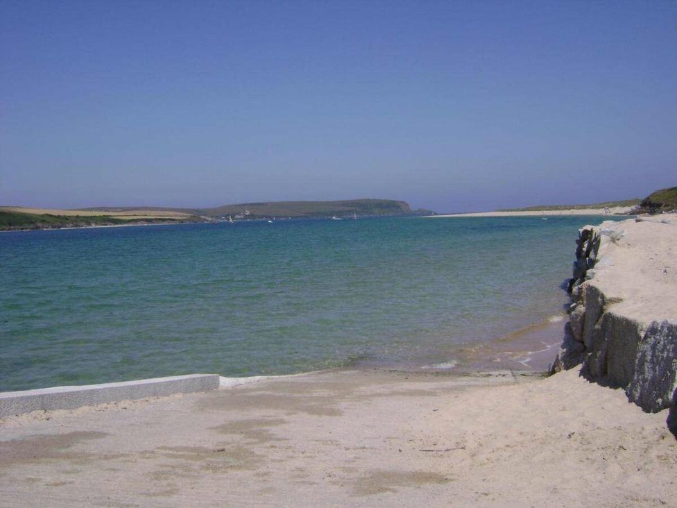 a beach with sandy shore and calm blue water at St Minver Holiday Park - Holiday Accommodation 21443, Wadebridge
