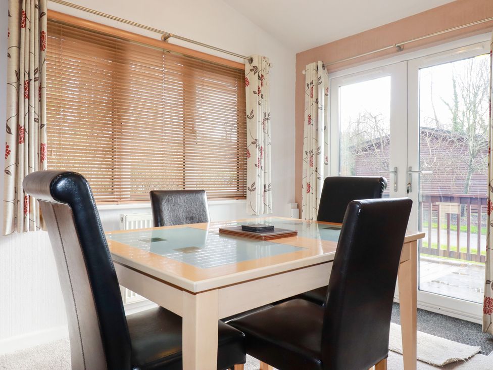 A dining room with a table and chairs at St Minver Holiday Park - Holiday Accommodation 21443 Wadebridge