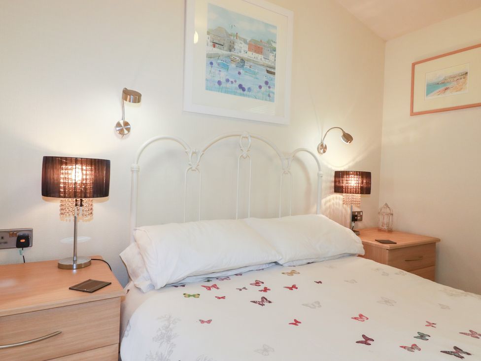 A bedroom with a bed and lamps at St Minver Holiday Park - Holiday Accommodation 21443 Wadebridge