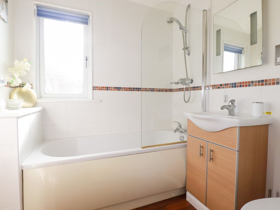A bathroom with a bathtub and shower at St Minver Holiday Park - Holiday Accommodation 21443 Wadebridge