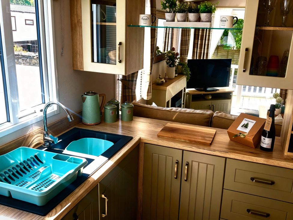 A kitchen with a sink and dish drainer at Aberdunant Hall Holiday Park - Holiday Accommodation 21962 in Prenteg