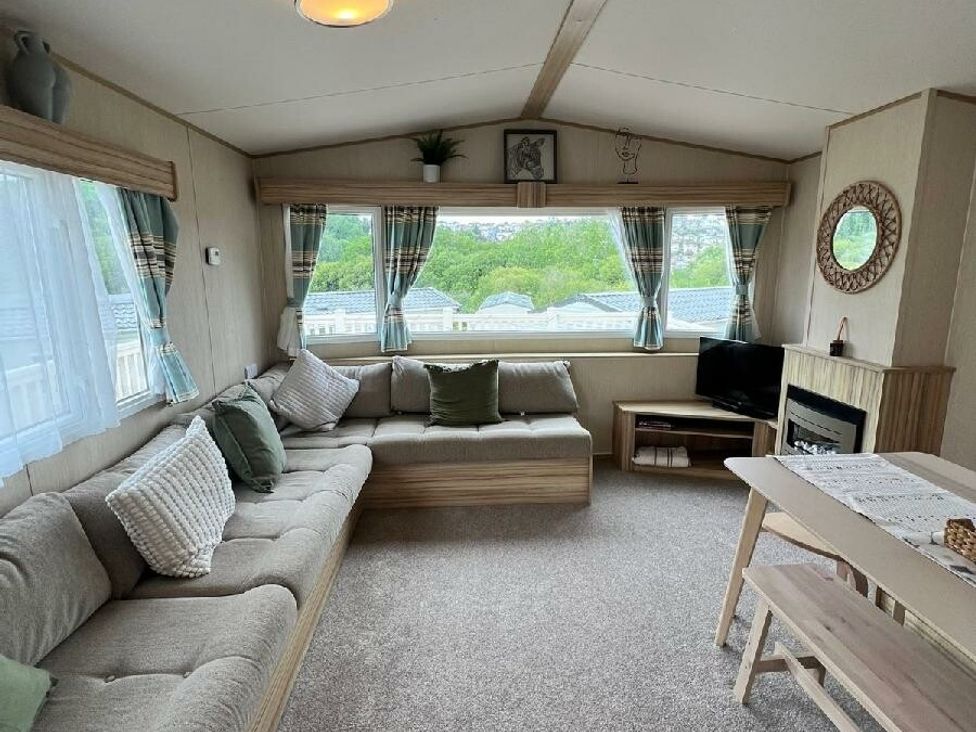 a living room with a sofa and a television at Hoburne Devon Bay - Holiday Accommodation 22090 Paignton