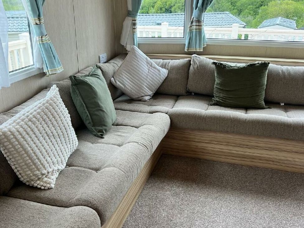a corner seating area with cushions at Hoburne Devon Bay - Holiday Accommodation 22090 in Paignton