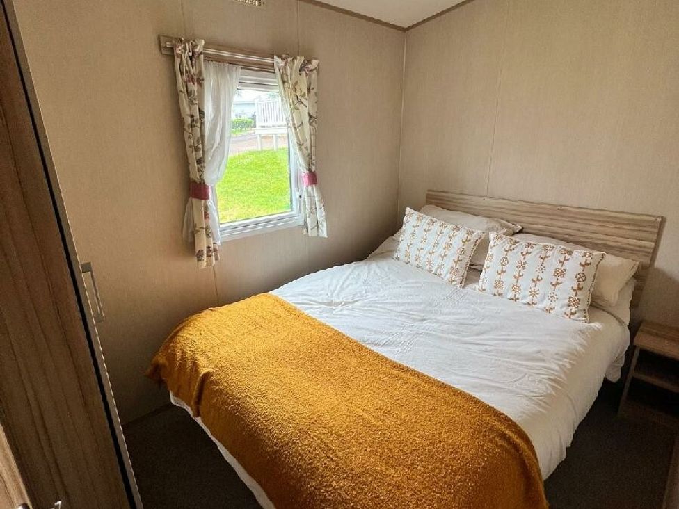 a bedroom with a double bed and window at Hoburne Devon Bay - Holiday Accommodation 22090 in Paignton