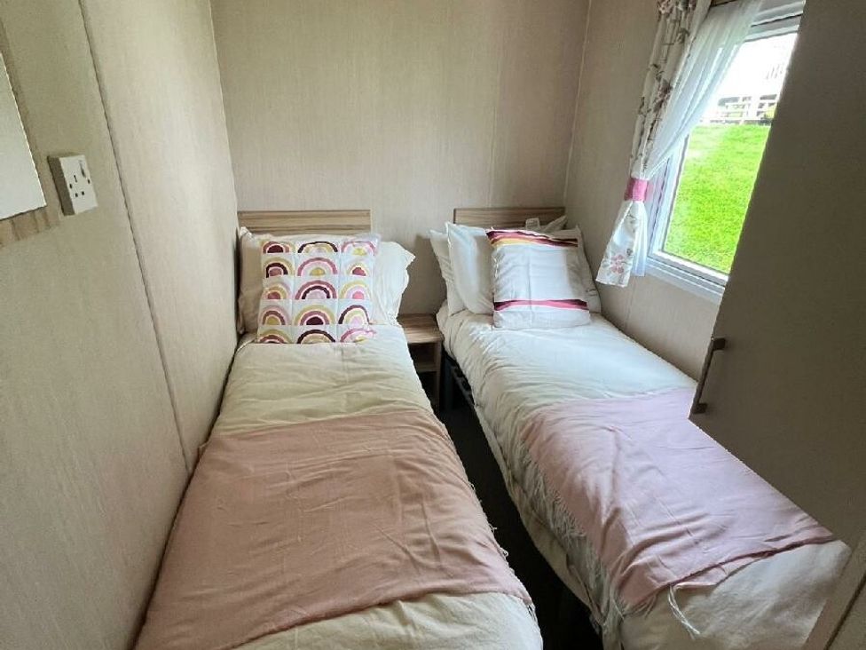 a bedroom with two single beds and a window at Hoburne Devon Bay - Holiday Accommodation 22090 in Paignton