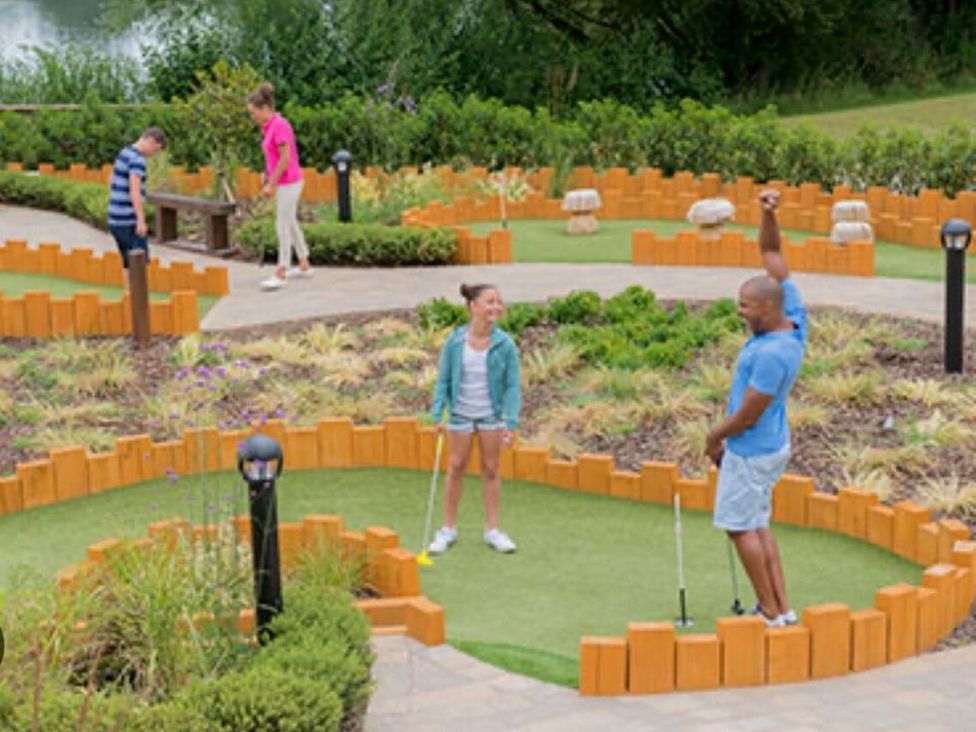a mini-golf area with players and landscaped features at Hoburne Devon Bay - Holiday Accommodation 22090 Paignton