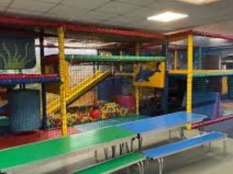 an indoor play area with colorful structures and slides at Hoburne Devon Bay - Holiday Accommodation 22090, Paignton