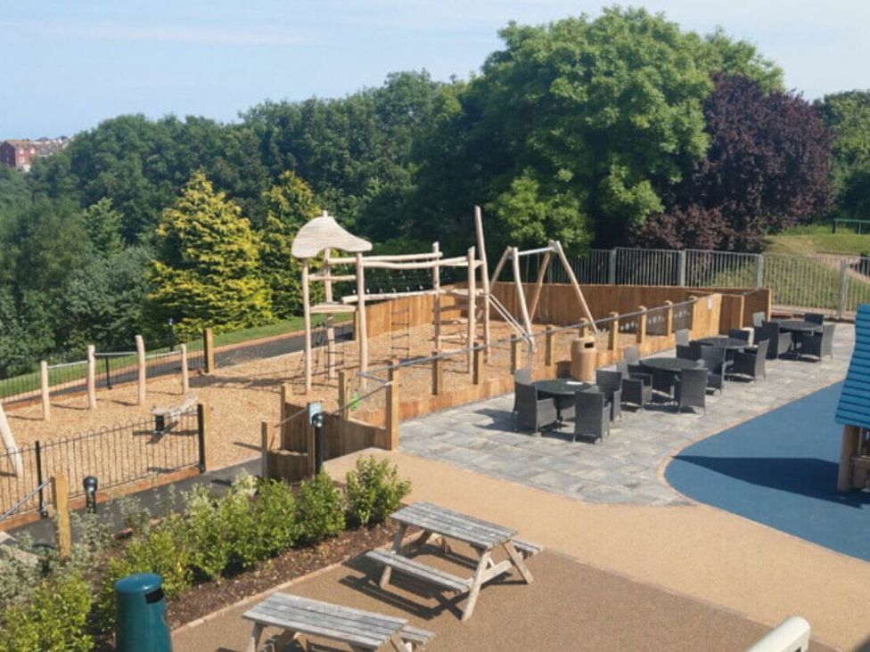a playground with climbing structures and seating areas at Hoburne Devon Bay - Holiday Accommodation 22090 in Paignton
