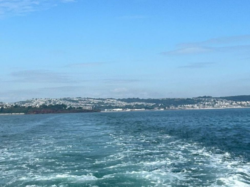 a view of water with a shoreline and hills in the background at Hoburne Devon Bay - Holiday Accommodation 22090, Paignton