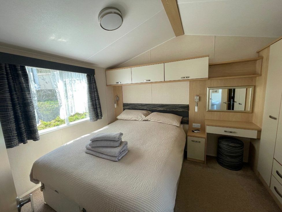 a bedroom with a double bed and a mirror at Waterside, Paignton - Holiday Accommodation 22105 in Paignton