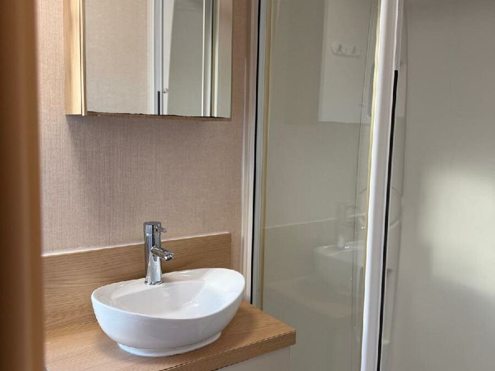 a bathroom with a round sink, mirror, and shower at Waterside, Paignton - Holiday Accommodation 22105 in Paignton