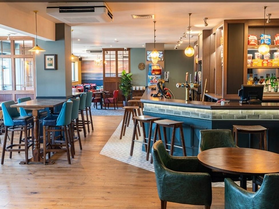 a bar area with tables and chairs at Waterside, Paignton - Holiday Accommodation 22105 Paignton