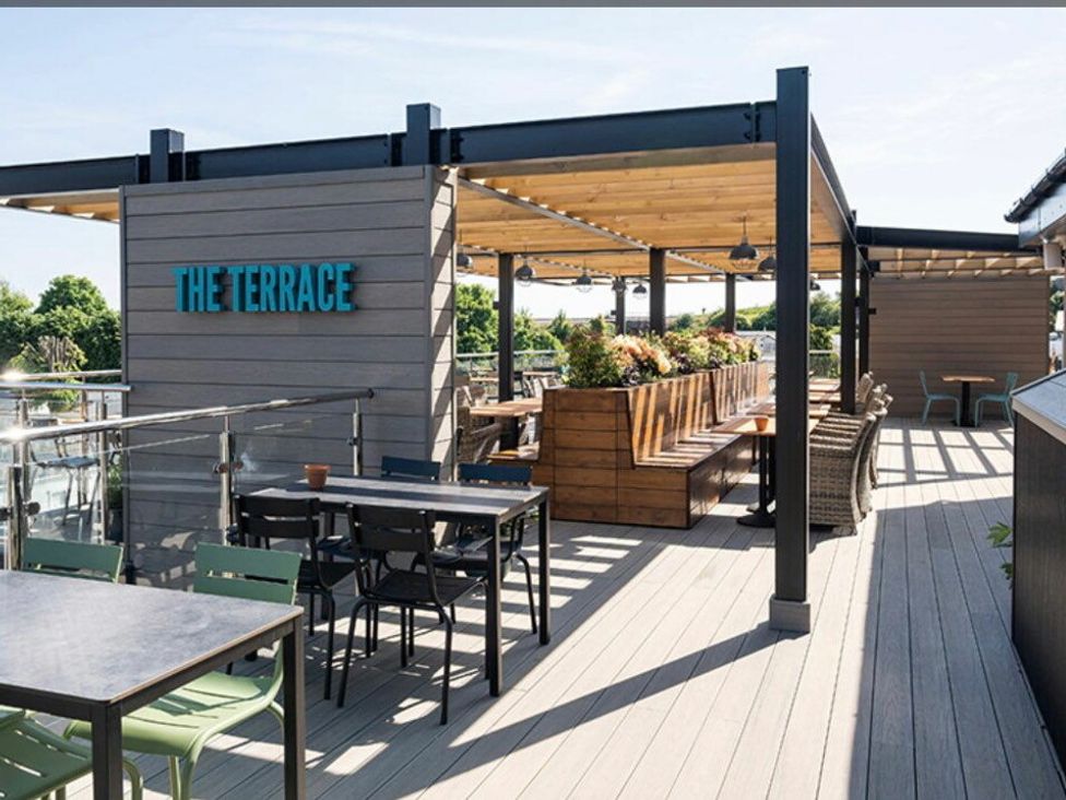 an outdoor terrace with seating and planters at Waterside, Paignton - Holiday Accommodation 22105, Paignton