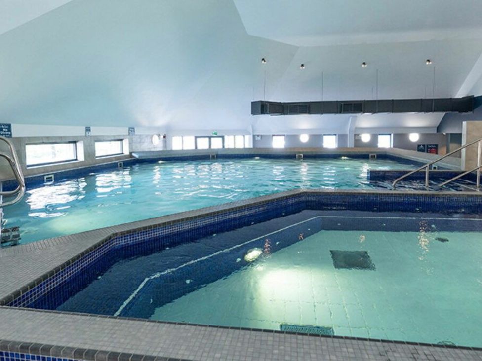 an indoor swimming pool with multiple sections and large windows at Waterside, Paignton - Holiday Accommodation 22105 in Paignton