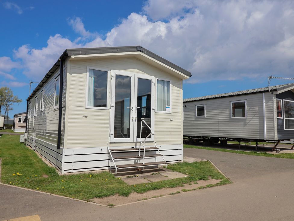 A mobile home with steps and front door at Ty Mawr Holiday Park - Holiday Accommodation 22393 Towyn