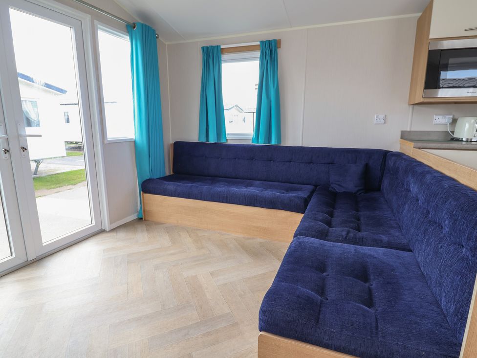 A living room with a sofa and window at Ty Mawr Holiday Park - Holiday Accommodation 22393 Towyn