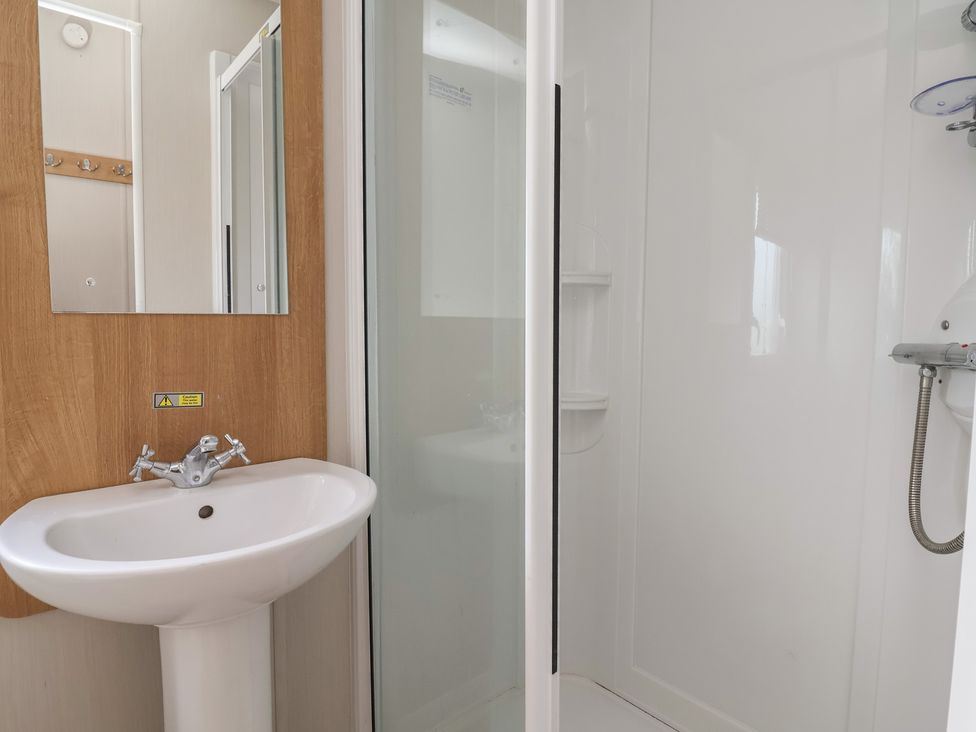 A bathroom with a sink and shower at Ty Mawr Holiday Park - Holiday Accommodation 22393 Towyn