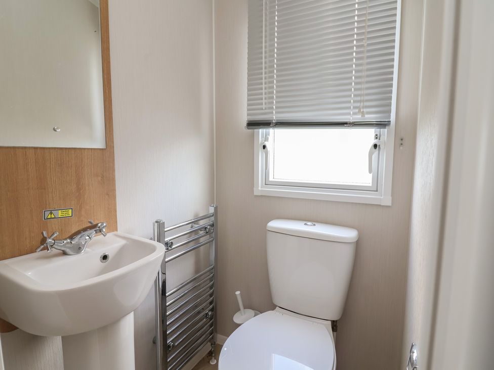 A bathroom with sink and toilet at Ty Mawr Holiday Park - Holiday Accommodation 22393, Towyn