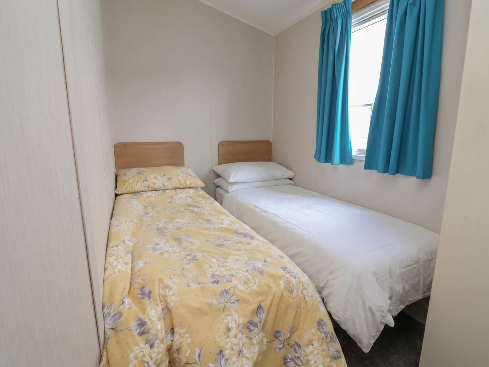 A bedroom with two beds and a window at Ty Mawr Holiday Park - Holiday Accommodation 22393 Towyn