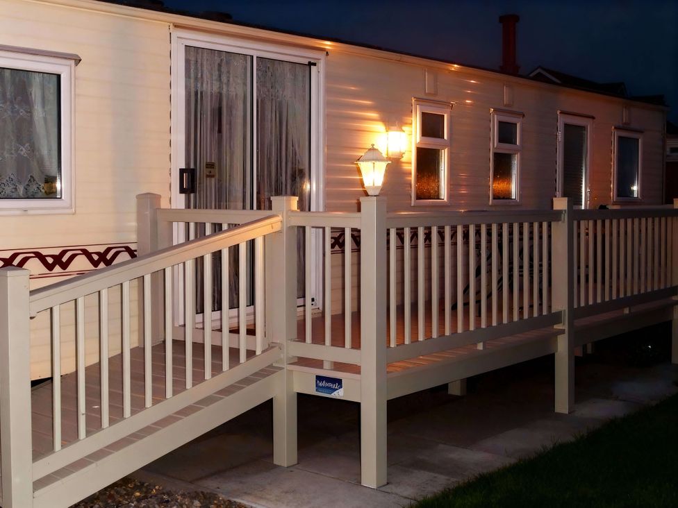 An outdoor view of a trailer with a deck and lighting at Coastfield Holiday Village - Holiday Accommodation 2604 Ingoldmells
