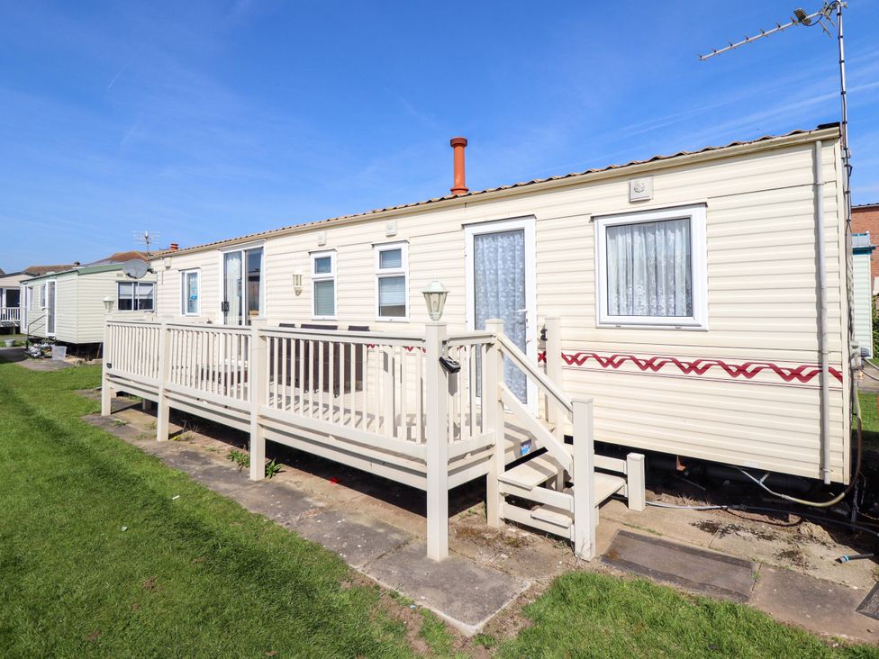 A caravan with decking and steps at Coastfield Holiday Village - Holiday Accommodation 2604 in Ingoldmells
