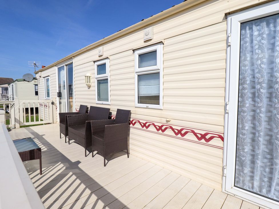 A patio area with seating and table at Coastfield Holiday Village - Holiday Accommodation 2604 Ingoldmells