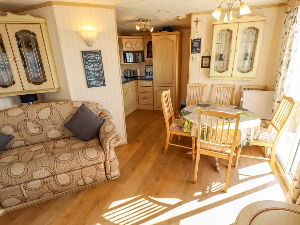 A living room with a sofa and dining area at Coastfield Holiday Village - Holiday Accommodation 2604 Ingoldmells