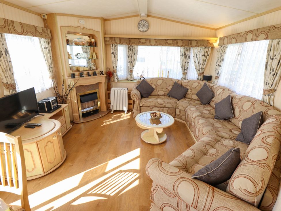 A living room with a sofa and television at Coastfield Holiday Village - Holiday Accommodation 2604 Ingoldmells