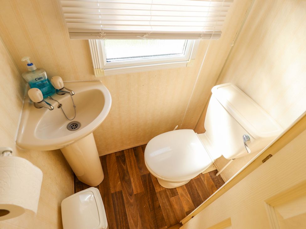 A bathroom with a sink and toilet at Coastfield Holiday Village - Holiday Accommodation 2604 in Ingoldmells