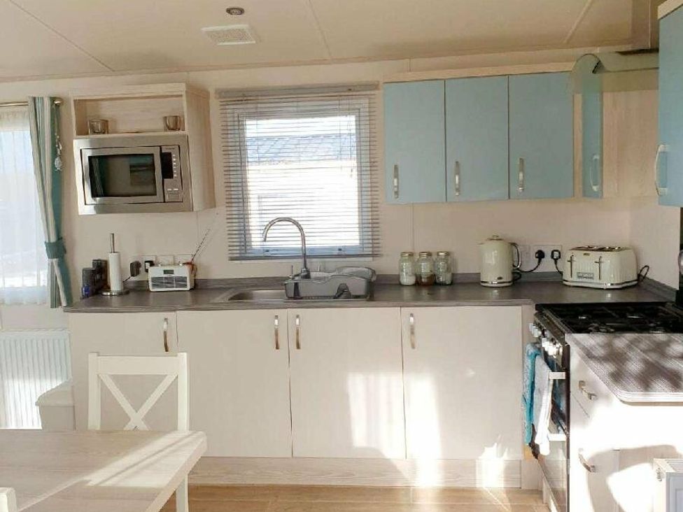 a kitchen with light cabinets and appliances at Shorefield Country Park - Holiday Accommodation 3042 in Milford On Sea